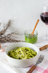 Pasta spaghetti with pesto sauce on a wooden background. National kitchen. Healthy eating. Vegetarian food. Recipe.
