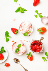 Bowl of pink strawberry ice cream and fresh berries on white background. Top view