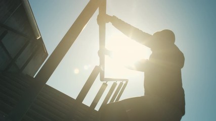 A fit sportsman jogging downstairs and doing parkour over the fence in slow motion - Powered by Adobe