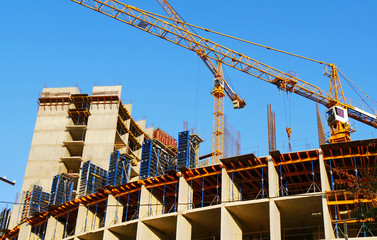 Two cranes near building. Construction site background.