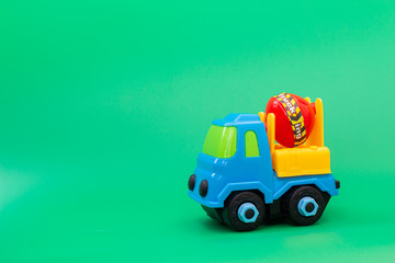 Construction machinery plastic  toy on green background
