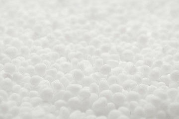 Naklejka premium White round urea fertilizer closeup. Chemical fertilizer carbamide. Mineral fertilizers are white balls of carbamide (urea). Background, texture.