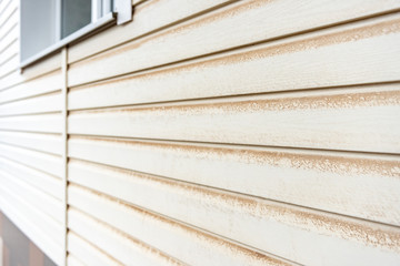 Dirty yellow siding with dust.