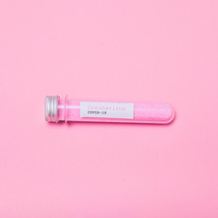 COVID-19 test and laboratory sample with pink glitter for diagnosis new Coronavirus infection on pink background. Flat lay.
