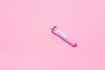 Minimal pop art. COVID-19 test and laboratory sample with pink glitter for diagnosis new Coronavirus infection on pink background. Flat lay.
