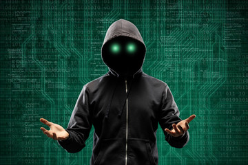 Computer hacker in mask and hoodie over abstract binary background. Obscured dark face. Data thief, internet fraud, darknet and cyber security.