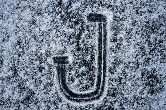 The letters of the English alphabet painted on the ice of a frozen lake - Powered by Adobe