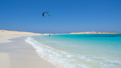 Fototapeta na wymiar Marsa Matruh, Egypt. The sandy beach and the amazing sea with tropical blue, turquoise and green colors. Relaxing context. Fabulous holidays. Mediterranean Sea. North Africa. Clean and pristine sea