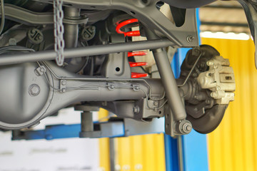 Pickup car independent suspension system, double wishbone, shock absorber and coil spring,Car suspension on lifter in car service.Close up.