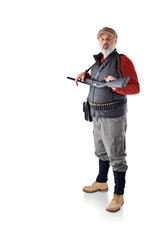 A man with a gray beard, in a cap, a black vest, with a bag and a gun in his hands isolated on a white background. The man is on the hunt.