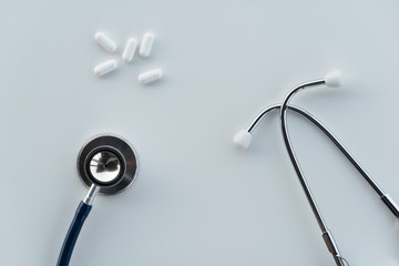 metal stethoscope for disease medical doctor diagnosis and white drug pill for therapy