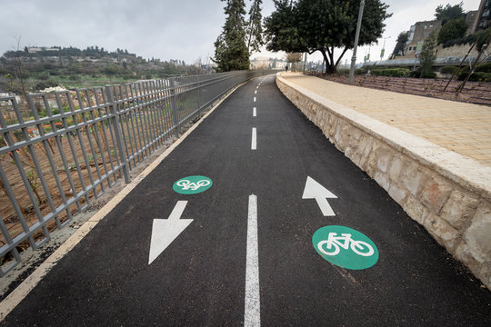 green and white paint on asphalt, To mark a bike path, wide angle photography.