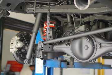 Pickup car independent suspension system, double wishbone, shock absorber and coil spring,Car suspension on lifter in car service.Close up.