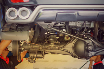 Suspension of drive car with new tire and Shock Absorber.Rear suspension of a modern car. Elements and design of the rear suspension. Rear suspension beam, spring, shock absorber.Close up.