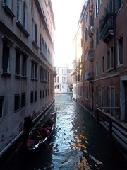 Fototapeta na wymiar Gondolier on Venice canals on a beautiful day