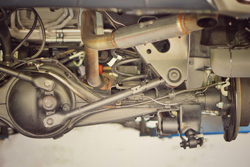 Suspension of drive car with new tire and Shock Absorber.Rear suspension of a modern car. Elements and design of the rear suspension. Rear suspension beam, spring, shock absorber.Close up.