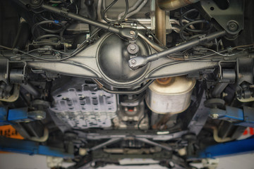 Suspension of drive car with new tire and Shock Absorber.Rear suspension of a modern car. Elements and design of the rear suspension. Rear suspension beam, spring, shock absorber.Close up.