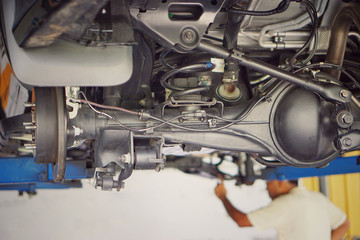 Suspension of drive car with new tire and Shock Absorber.Rear suspension of a modern car. Elements and design of the rear suspension. Rear suspension beam, spring, shock absorber.Close up.