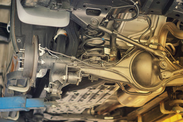 Suspension of drive car with new tire and Shock Absorber.Rear suspension of a modern car. Elements and design of the rear suspension. Rear suspension beam, spring, shock absorber.Close up.