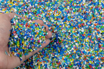 Close-up of plastic polymer granules. hand hold Polymer pellets. polymer plastic. compound polymer.