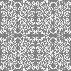Ornate vintage wallpaper with white victorian tracery on grey background