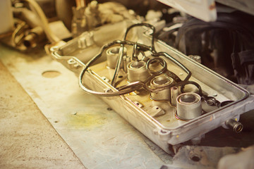 Car engine machine repairing by technician to change some part and modify something for return to using in car drive.Engine can't start need to repair.The mechanic is checking the engine.Close up. 