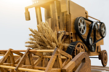 Toy wooden harvester with wheat branches