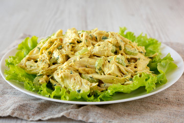 Homemade Coronation Chicken Salad on a white plate, side view. Close-up.