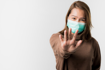 Asian young woman wearing a hygiene protective mask over her face on White background,Coronavirus...