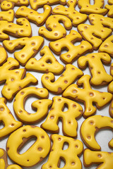 Yellow letters made from gingerbread biscuit background.