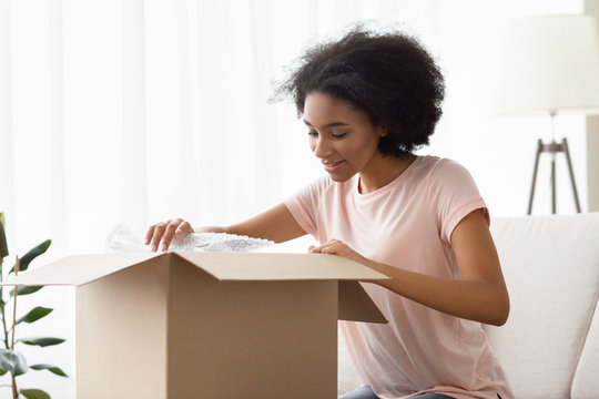 Girl with big box of purchases from online store