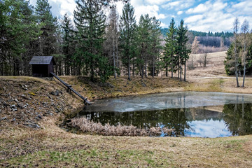 Fototapeta na wymiar Water reservoir in Stiavnica Mountains, Slovakia, seasonal natural scene