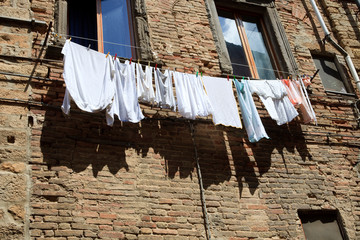 Volterra (SI), Italy - April 25, 2017: Clothes drying in front of old house, Volterra, Tuscany, Italy