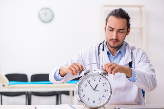 Young handsome male doctor working in the clinic