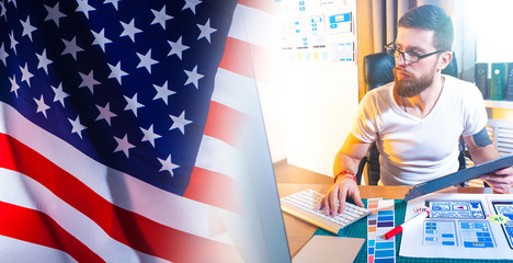 Mobile app developer on the background of the American flag. Website development for an American company. The design of mobile applications. Remote work.