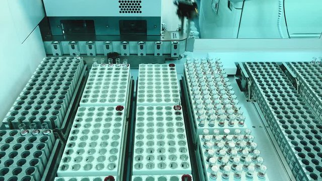 Top view of automatic medical analyzer of biological material in science laboratory. Scientific electrical equipment. Concept of healthcare and laboratory diagnostic.