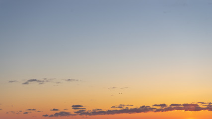 Beautiful clear, morning sky at sunrise, natural background. Soft gradient from orange to blue.