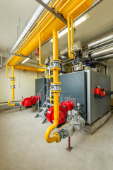 interior of an industrial gas boiler room with boilers and pipelines