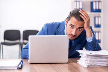 Young male businessman working in the office