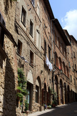 Fototapeta na wymiar Volterra (SI), Italy - April 25, 2017: Typical houses in centre of Volterra, Tuscany, Italy