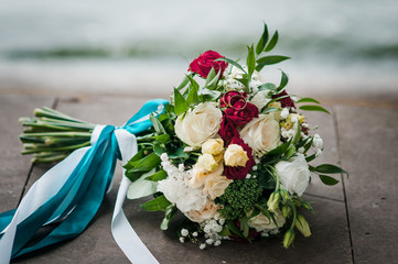 Gold wedding rings on the bouquet of flowers