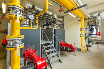 interior of an industrial gas boiler room with boilers and pipelines