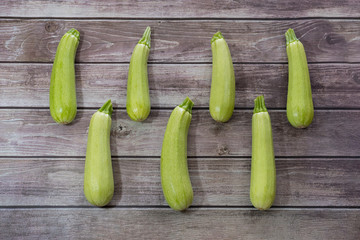 Fresh zucchini on wooden background