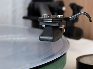 Fototapeta na wymiar Close-up of a record player stylus above the white vinyl LP.