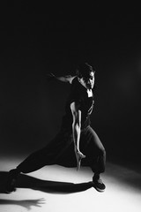 A dancer in red slacks and a t- shirt