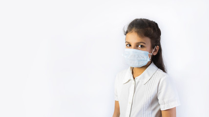 Coronavirus and Air pollution concept. Little indian or pakistani girl wearing mask for protect pm2.5. Isolated on white background.