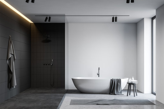 White and black bathroom with tub and shower