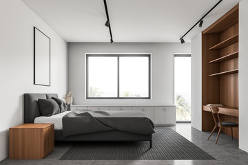 White and wooden bedroom with table and window