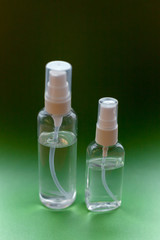 Bottle of hand sanitizer, antimicrobial liquid gel, germ prevention or antibacterial hygiene. Green background, for the prevention of coronavirus, a copy of the space