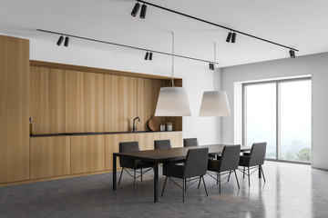 White and wooden kitchen with dining table